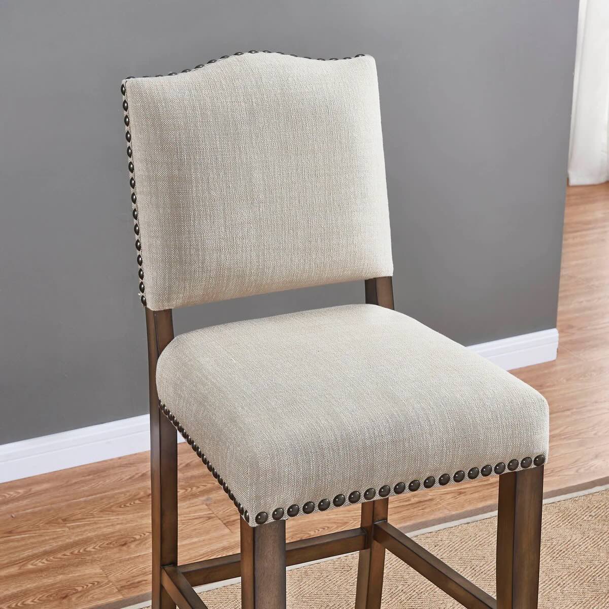 Closeup of American Heritage Worthington stool in Coastal Grey finish and linen upholstry.