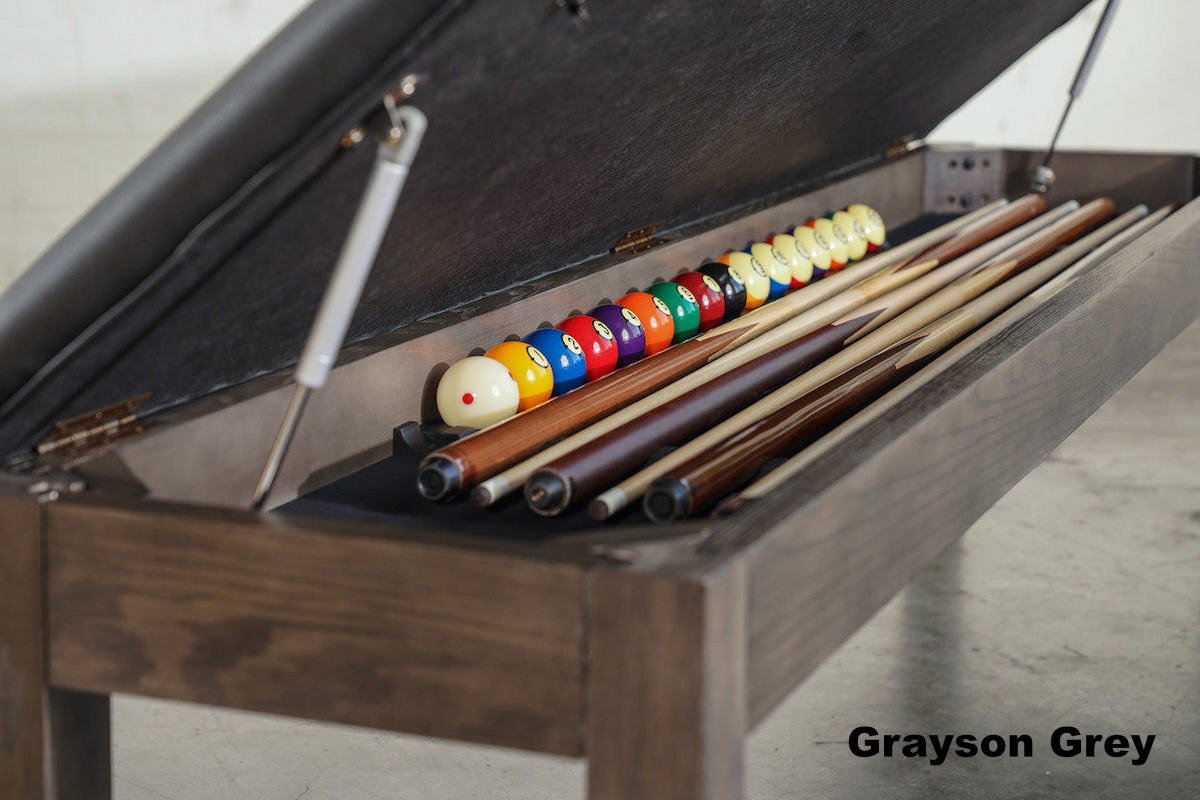 Billiard balls and cues stored under the seat of a Nixon Billiards pool table bench.