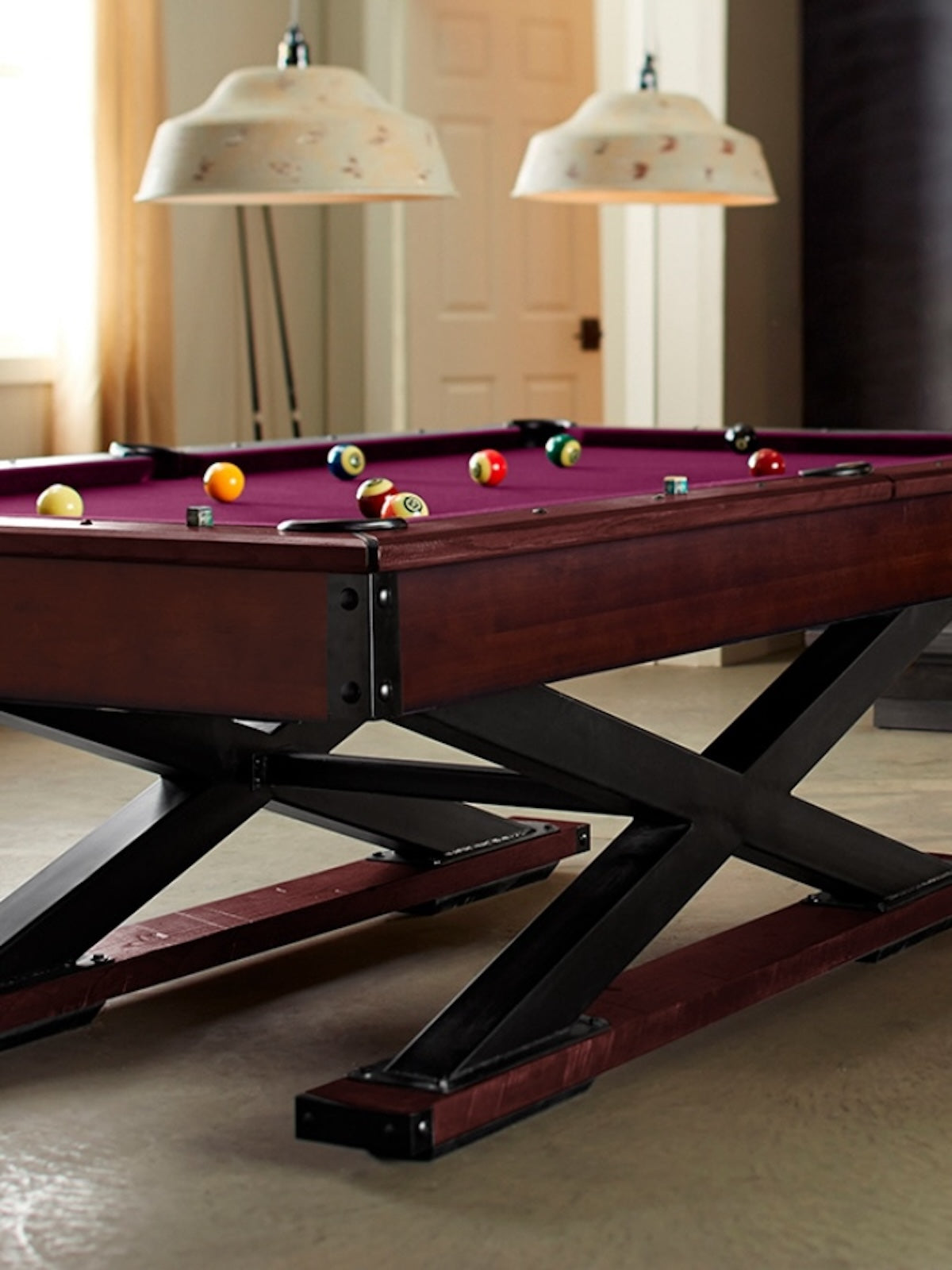 A Quest slate pool table by American Heritage in Navajo centered in the middle of a game room.