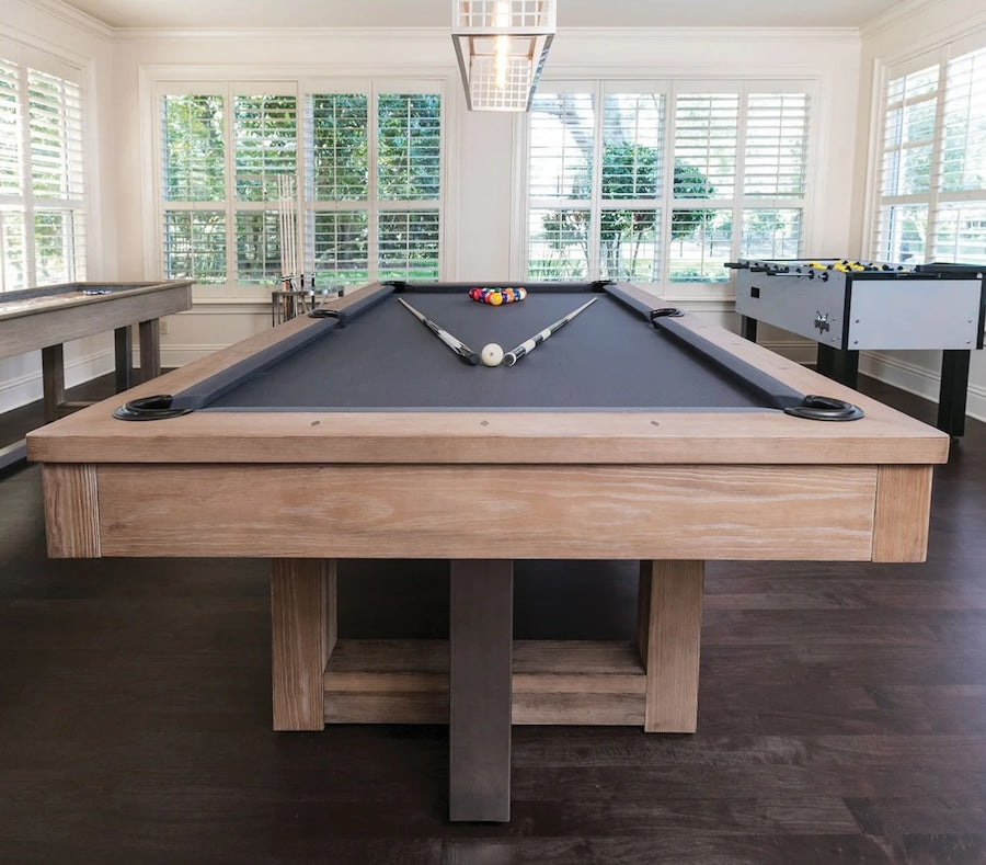 A game room with an American heritage Abbey pool table with and shuffleboard along with an American Heritage foosball table.