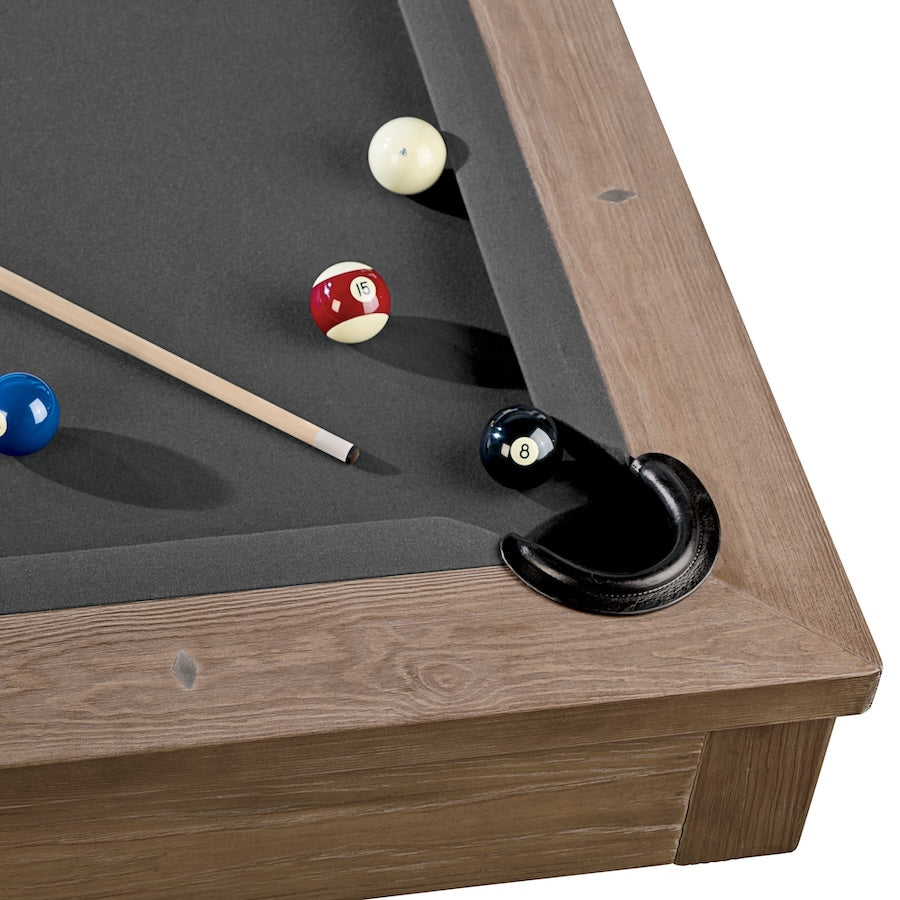 A closeup on the corner pocket of an Abbey slate pool table with an Antique Gray wood finish. Designed by American Heritage.