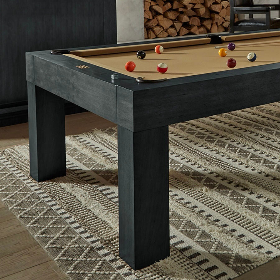 The Alta billiard table designed by American Heritage in a Black Ash finish centered in a game room. Khaki felt cloth.
