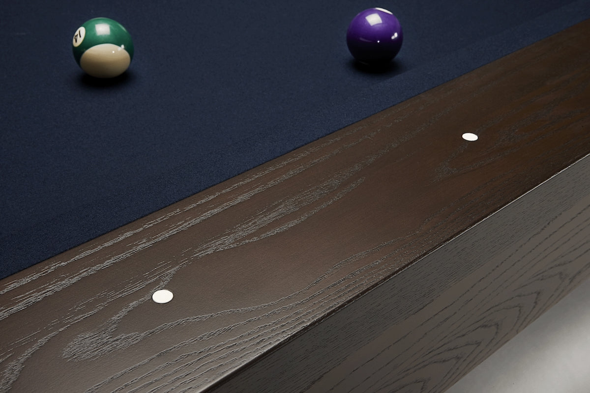 The white round sights on a Deerfield slate pool table designed by American Heritage.