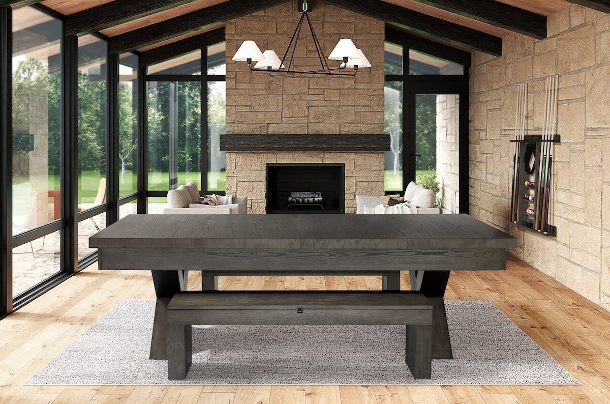 The American Heritage Halifax pool table complete with dining top, storage benches, and wall cue rack dominate this game room.