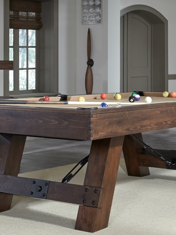 A Game Room with the Savannah billiard table by American Heritage in a Sable finish and khaki felt.