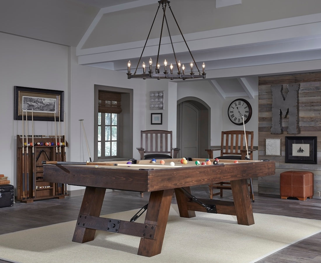 The Savannah slate pool table by American Heritage with a Sable finish and khaki felt is the centerpiece of this game room.