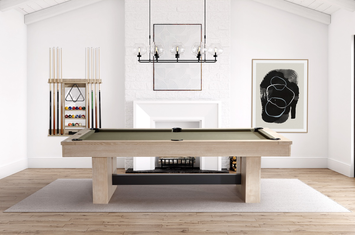Side view of the Vancouver Natural Ash pool table in a game room with an American Heritage pool cue rack hanging on the wall.