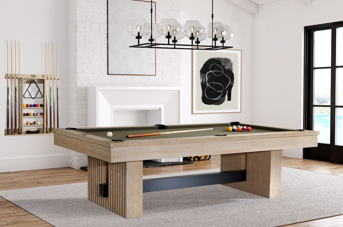 Angled view of a game room with the Vancouver slate pool table in a Natural Ash finish by American Heritage in the center of the room.