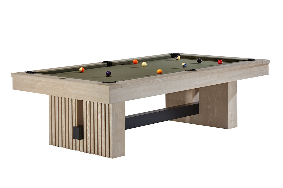 The Vancouver pool table by American Heritage in a Natural Ash finish with pool balls scattered on top.
