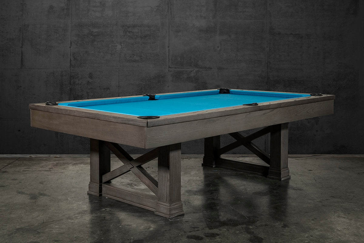 The Agriturismo pool table in charcoal viewed from one corner of the table in an industrial style game room.