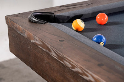 Billiard balls lie near a leather-lined corner pocket of an Agriturismo pool table.