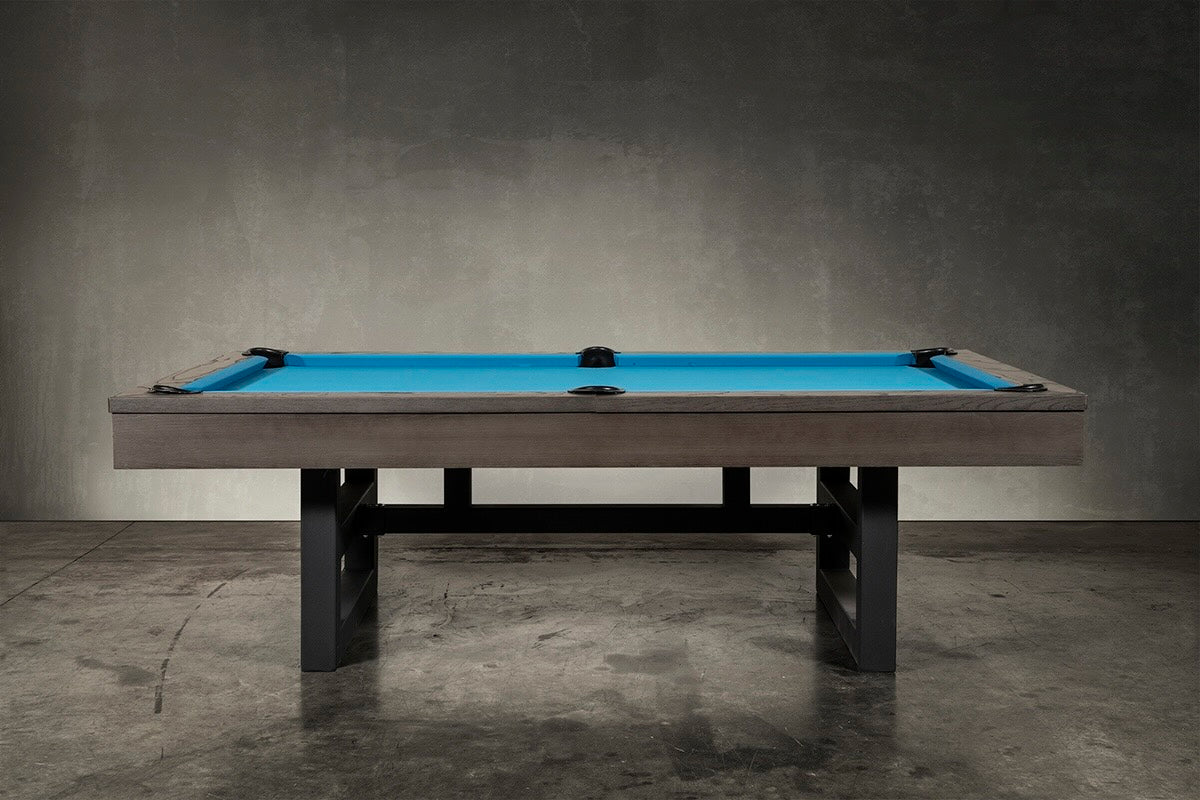 Chino slate pool table with charcoal finish and blue billiard cloth in industrial style game room.