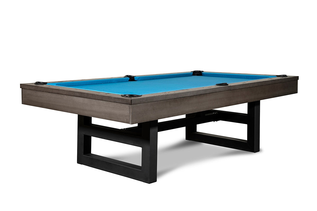 Chino slate pool table viewed from a one of its corners with charcoal wood finish and blue billiard cloth.