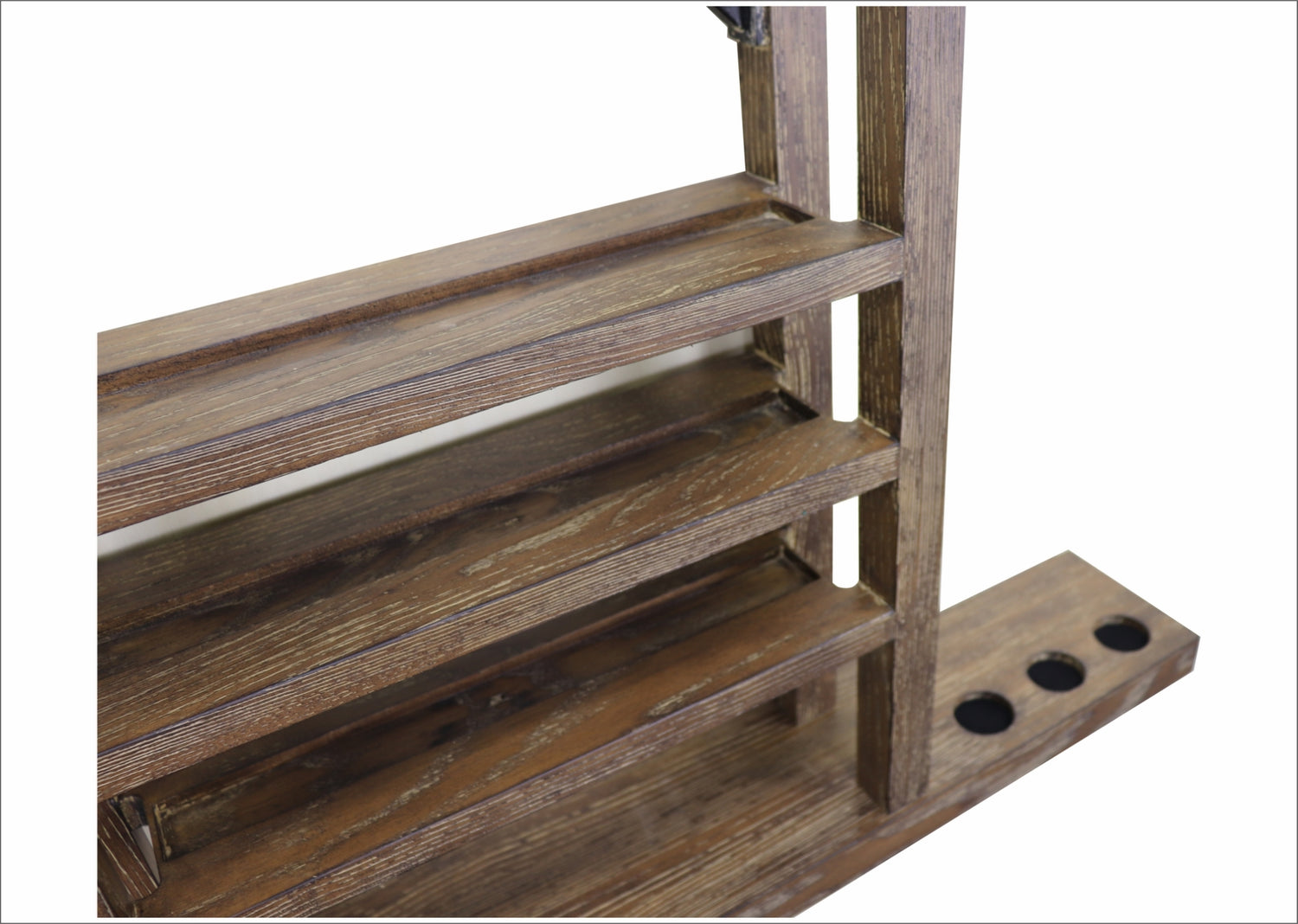 A closeup of the Nixon Hunter wall rack in a Brushed Walnut finish, focusing on the lower right side of the rack.