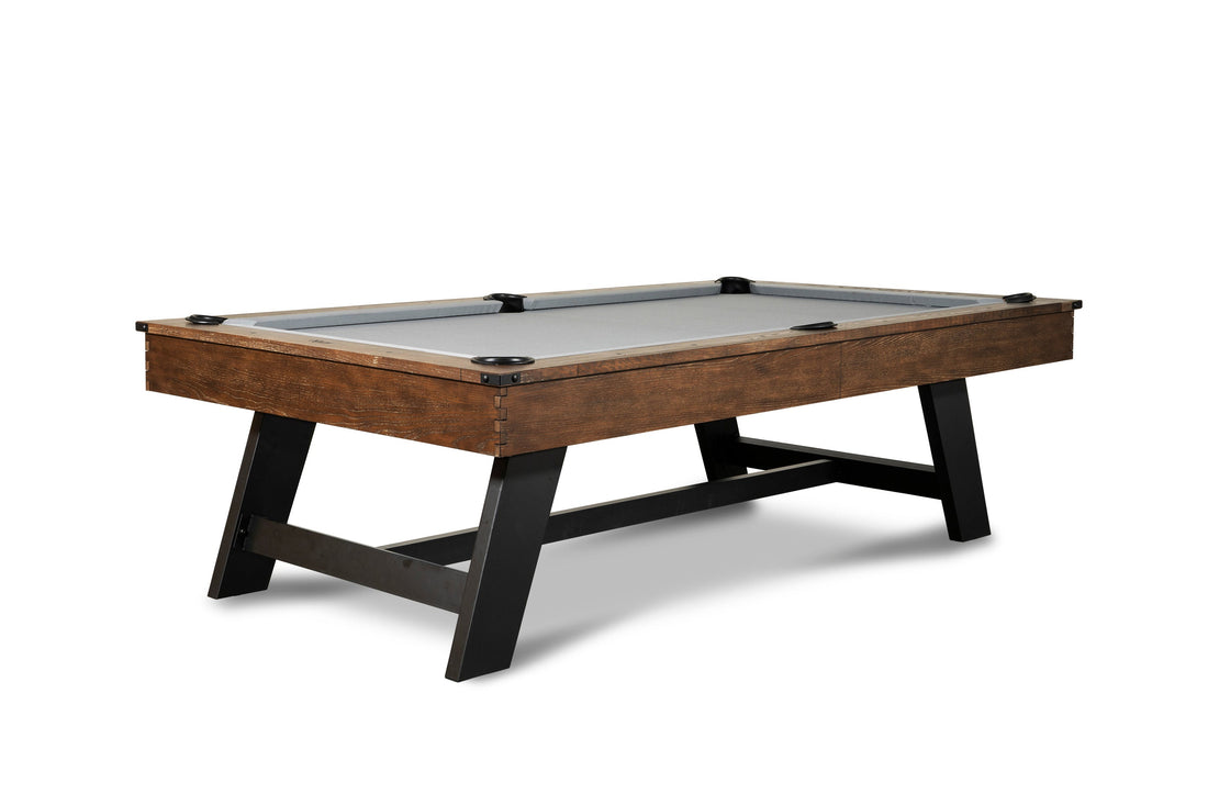 Nixon Hunter slate pool table with brushed walnut wood frame, black metal legs, gray felt, and leather drop pockets.