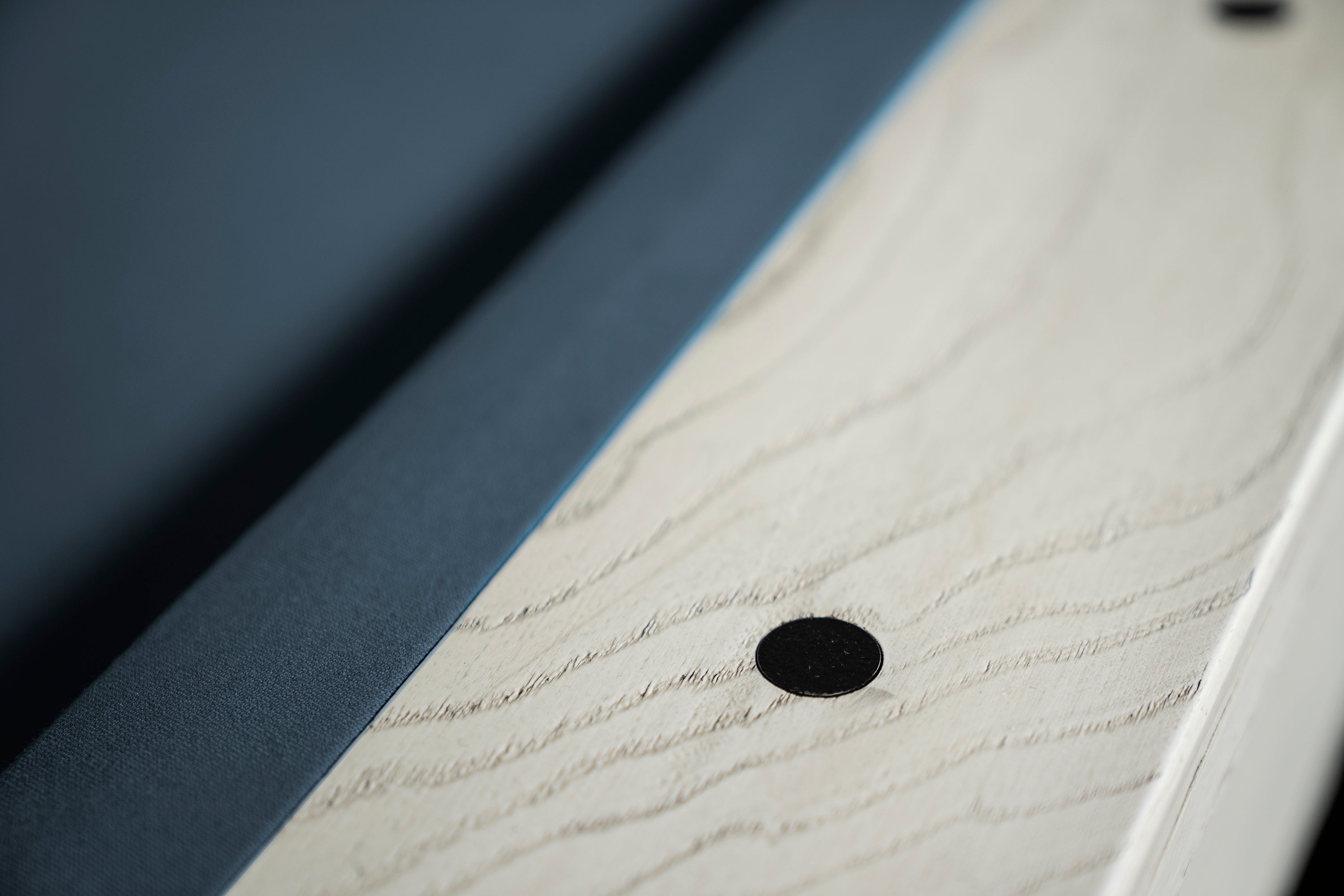 A very close shot of the round black sights on the Isabella Agriturismo slate pool talble in whitewash.