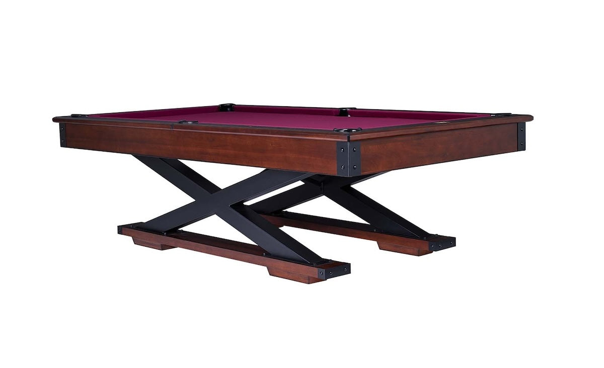 The Quest pool table in a Navajo finish designed by American Heritage with dark magenta-colored felt.