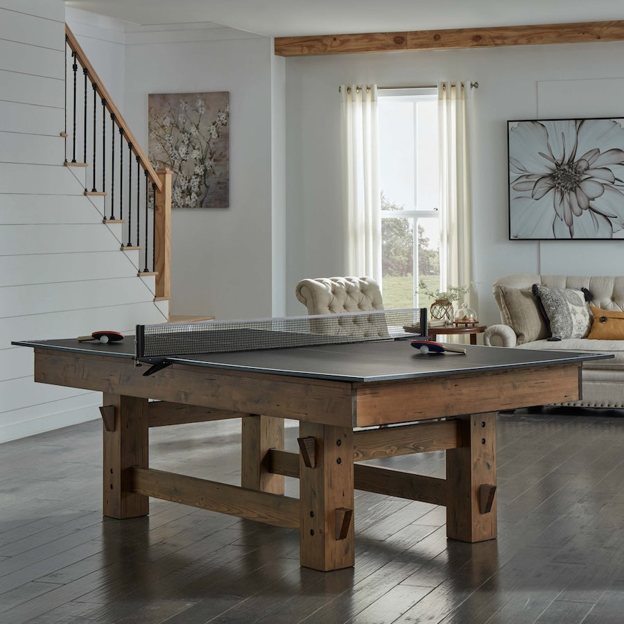 The American Heritage Bristol slate pool table with a table tennis top pictured in a game room.