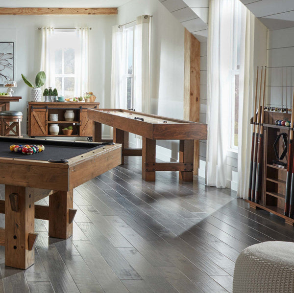 The American Heritage Bristol pool table with a Harvest finish in a game room complete with an American Heritage shuffleboard and pool cue rack.