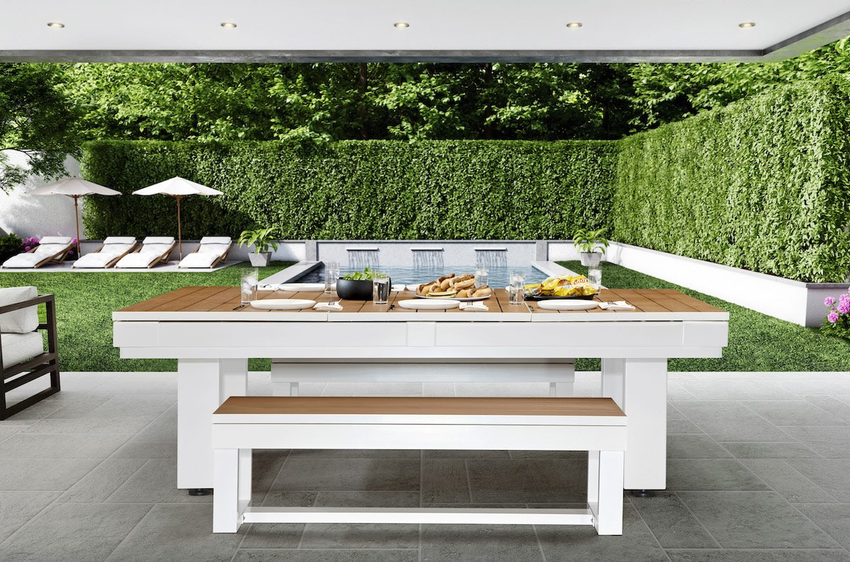 The American Heritage Lanai pool table in a Pearl White finish with a dining top set with food.