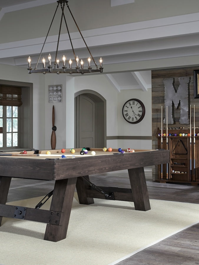 A Savannah billiard table by American Heritage with a Charcoal finish is the statement piece of this game room.