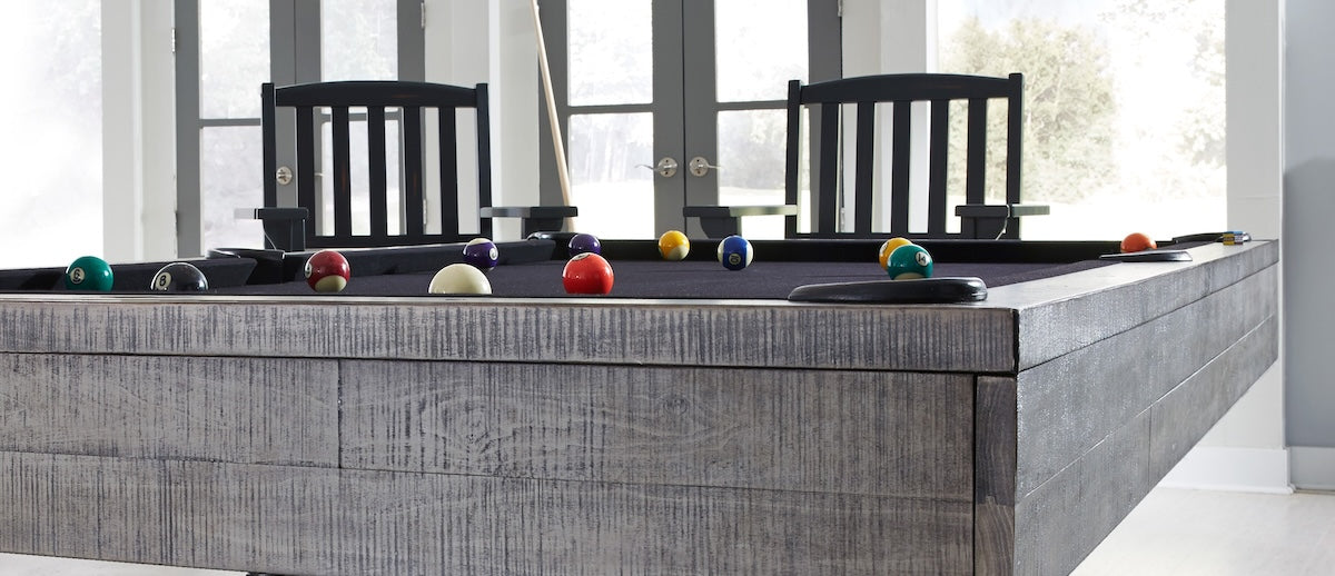 Side view of the American Heritage Victory billiard table by with spectator chairs designed by American Heritage. 
